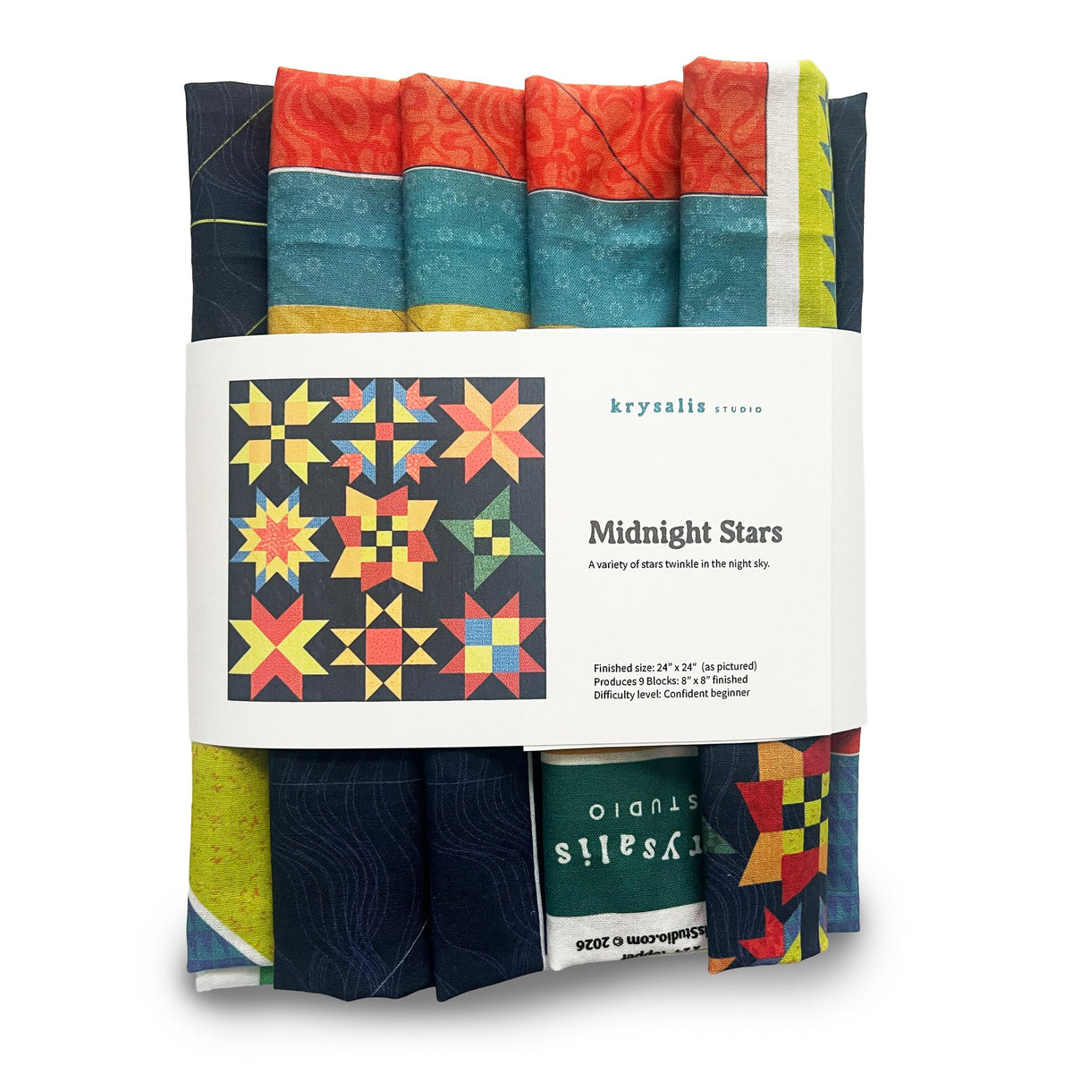 A bundle of vibrant cotton fabric wrapped in a white paper band labeled 'krysalis studio Midnight Stars quilt kit', showing 9 different star themed quilt blocks including navy, teal, orange, yellow, green, and red starburst and geometric patterns.