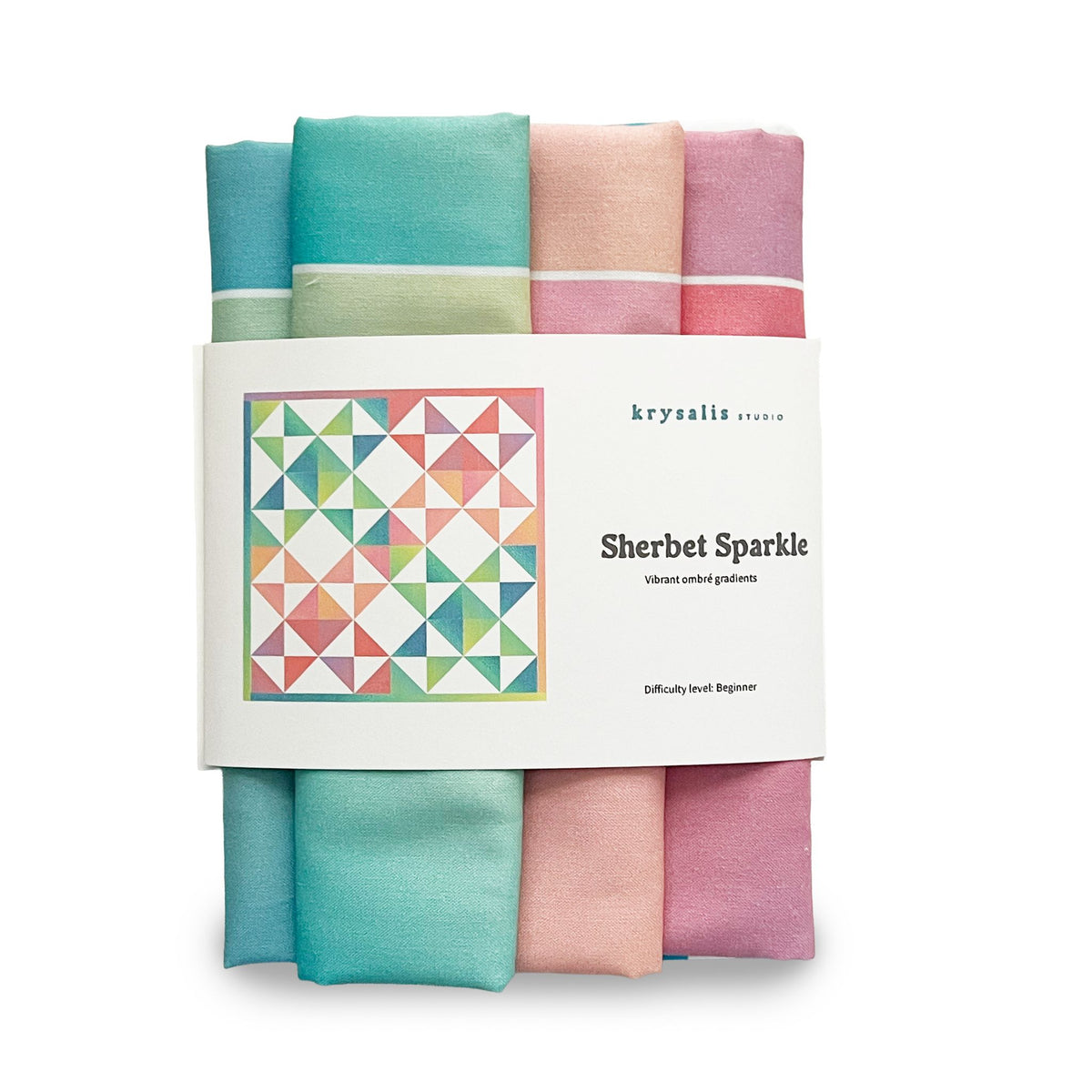 A bundle of folded fabric squares in pastel and bright colors, wrapped with a white paper label that reads 'krysalis studio' and 'Sherbet Sparkle'. The fabrics include shades of teal, mint green, pink, peach, and purple.